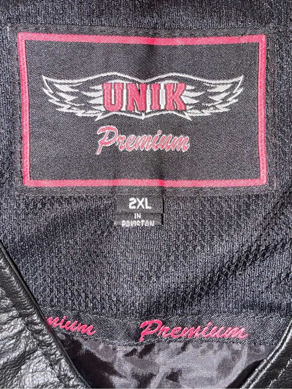 UNIK premium leather biker vest with pink leather lacing and pretty pink rose.